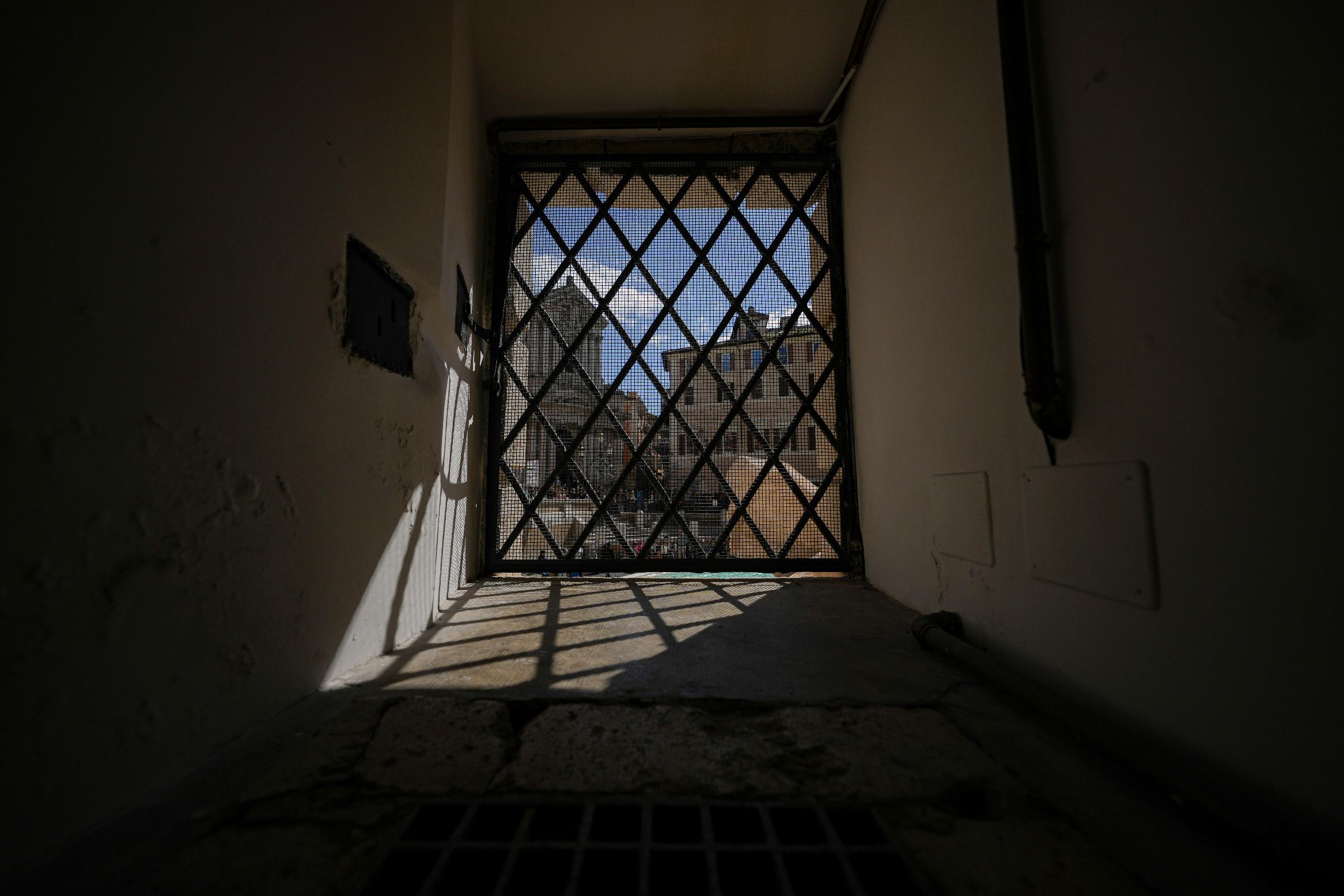 Rome's Trevi fountain is seen through a window of its old water flow control room, Wednesday, March 19, 2025. (AP Photo/Andrew Medichini)