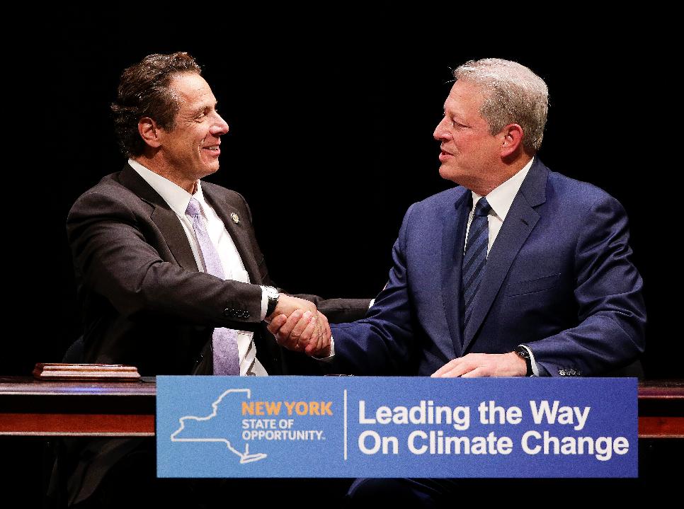 FILE - New York Gov. Andrew Cuomo, left, shakes hands with former Vice President Al Gore after signing a memorandum of understanding to join the Under 2 MOU coalition, Oct. 8, 2015, in New York. (AP Photo/Julie Jacobson, File)
