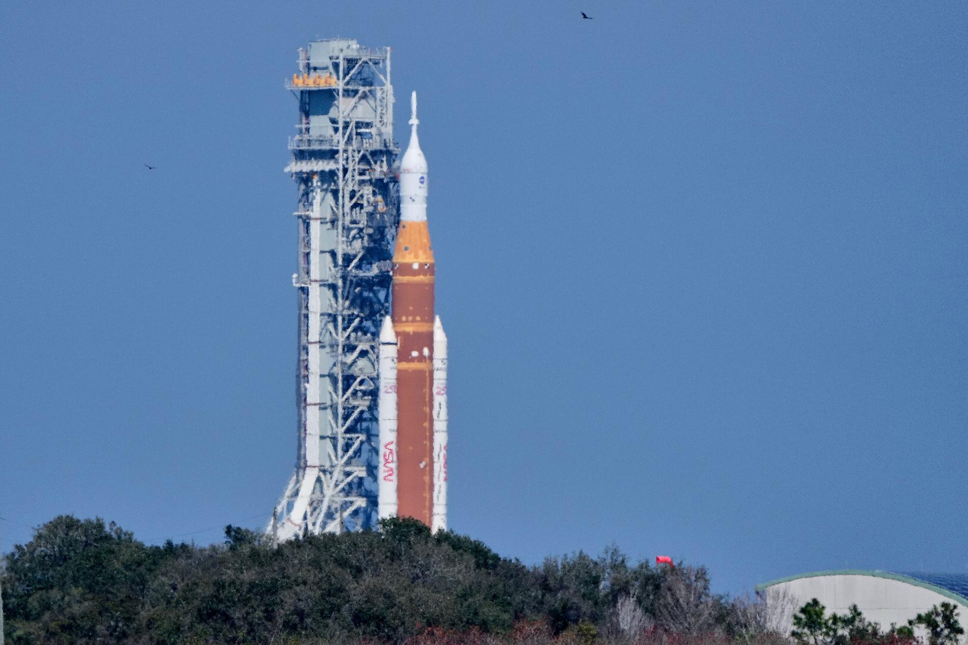 NASA's Artemis II SLS (Space Launch System) moon rocket with the Orion spacecraft slowly rolls back towards the Vehicle Assembly Building at the Kennedy Space Center, Wednesday, Feb. 25, 2026, in Cape Canaveral, Fla. (AP Photo/John Raoux)
