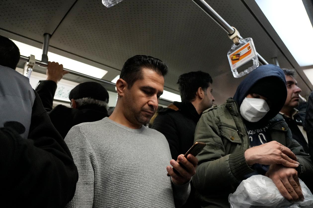 A man uses his smartphone while riding the subway in Tehran, Iran, Tuesday, Dec. 24, 2024. (AP Photo/Vahid Salemi)