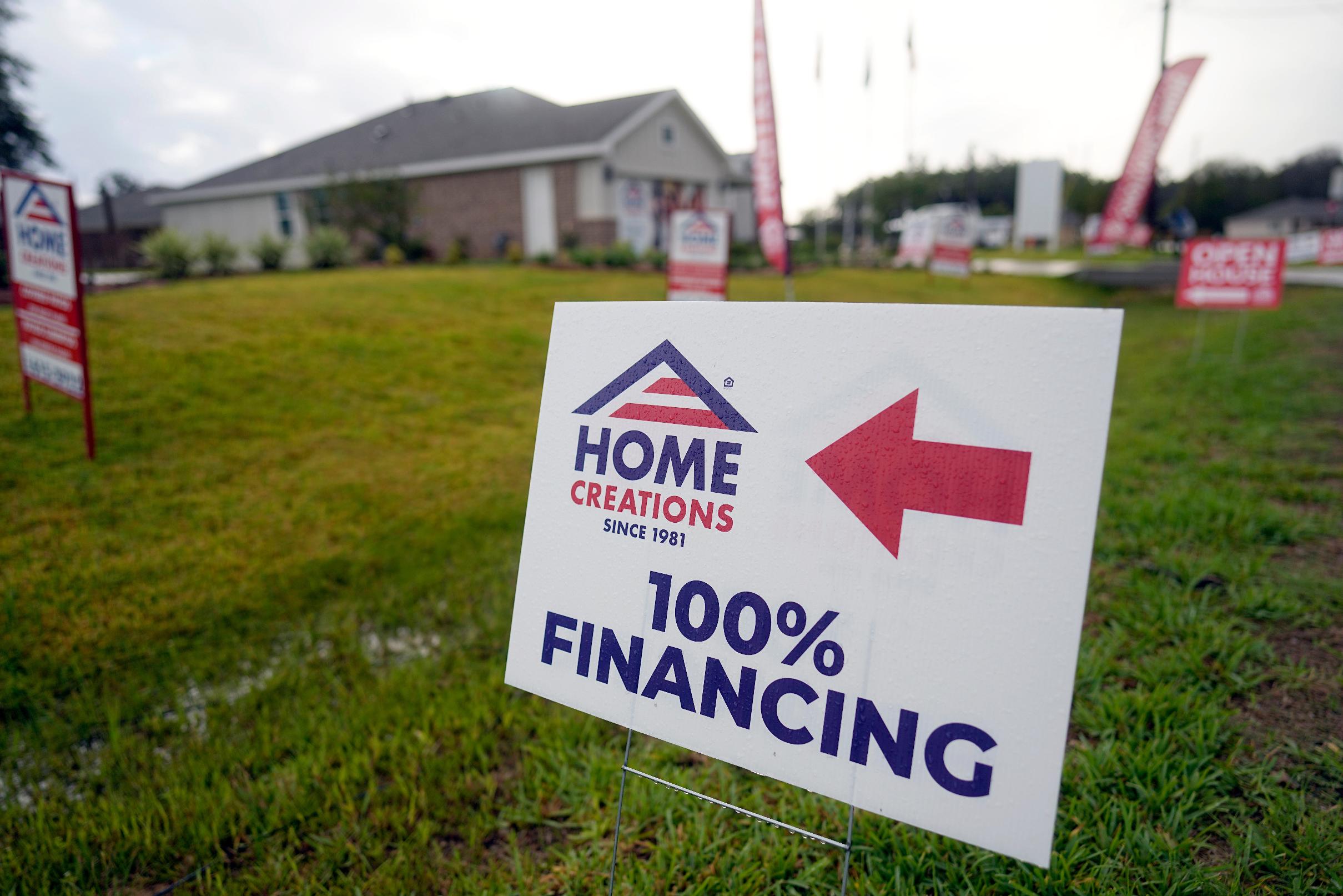 FILE - A sign promoting 100% financing is displayed outside a model home in the Colony Ridge development in Cleveland, Tx., Oct. 3, 2023. (AP Photo/David J. Phillip, File)