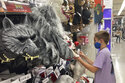 A young customer looks at a Halloween mask at a Party City store, Wednesday, Oct. 6, 2021, in Miami. Americans continued to spend at a solid clip in September despite rising prices and snarled global supply chains that are limiting the flow of goods. Retail sales rose a seasonally adjusted 0.7% in September from the month before, the U.S. Commerce Department said Friday, Oct. 15. (AP Photo/Marta Lavandier)