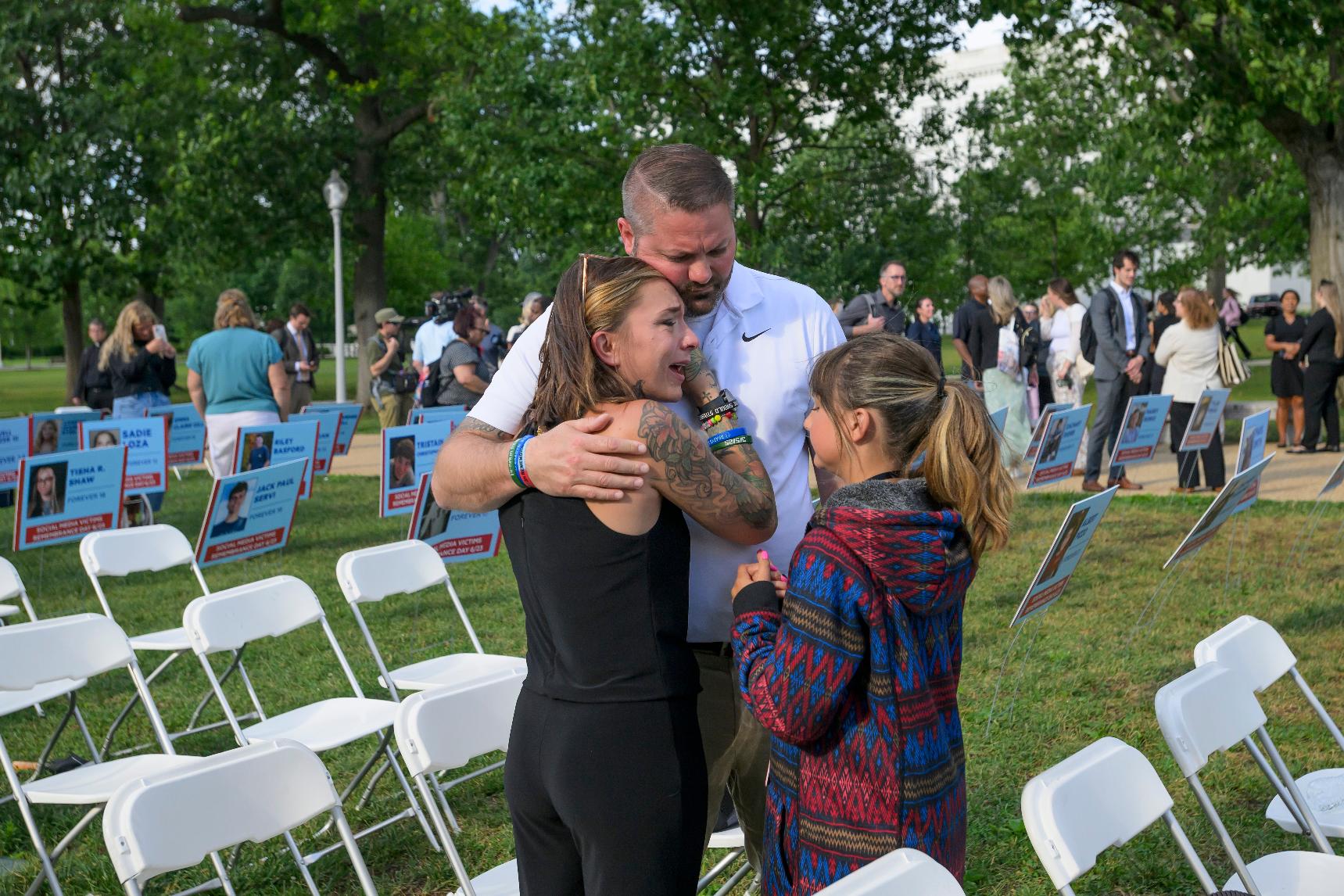 Brittney Bird, from left, is comforted by her husband Luke Bird and daughter Aurora Bird as they remember her son Bradyn Bohn, 15, during a Social Media Victims Remembrance Day memorial on Capitol Hill, Tuesday, June 23, 2026, in Washington. (AP Photo/Rod Lamkey, Jr.)