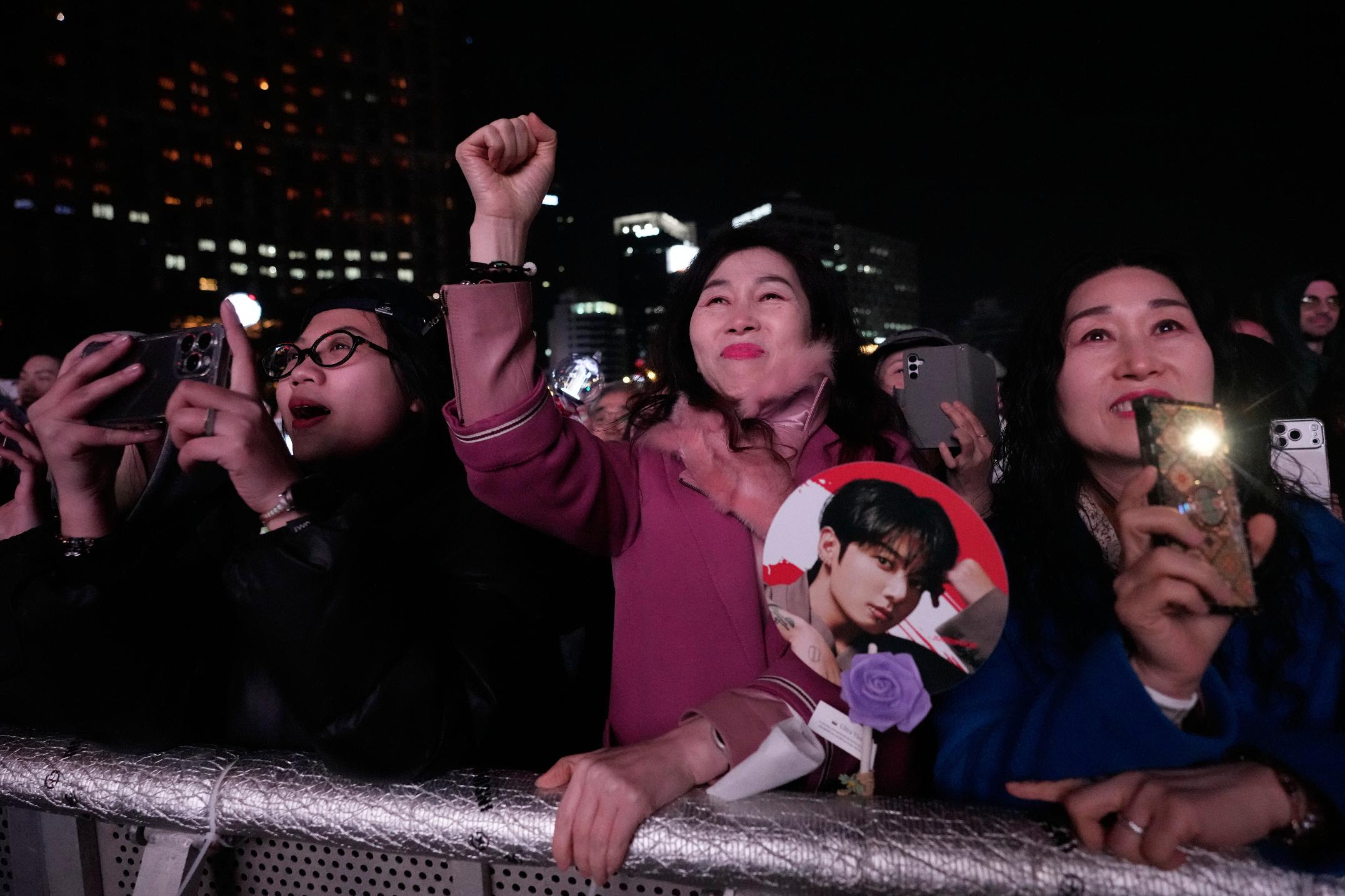 FILE - Fans react during a comeback concert of K-pop band BTS near Gwanghwamun Square in Seoul, South Korea, Saturday, March 21, 2026. (AP Photo/Ahn Young-joon, File)