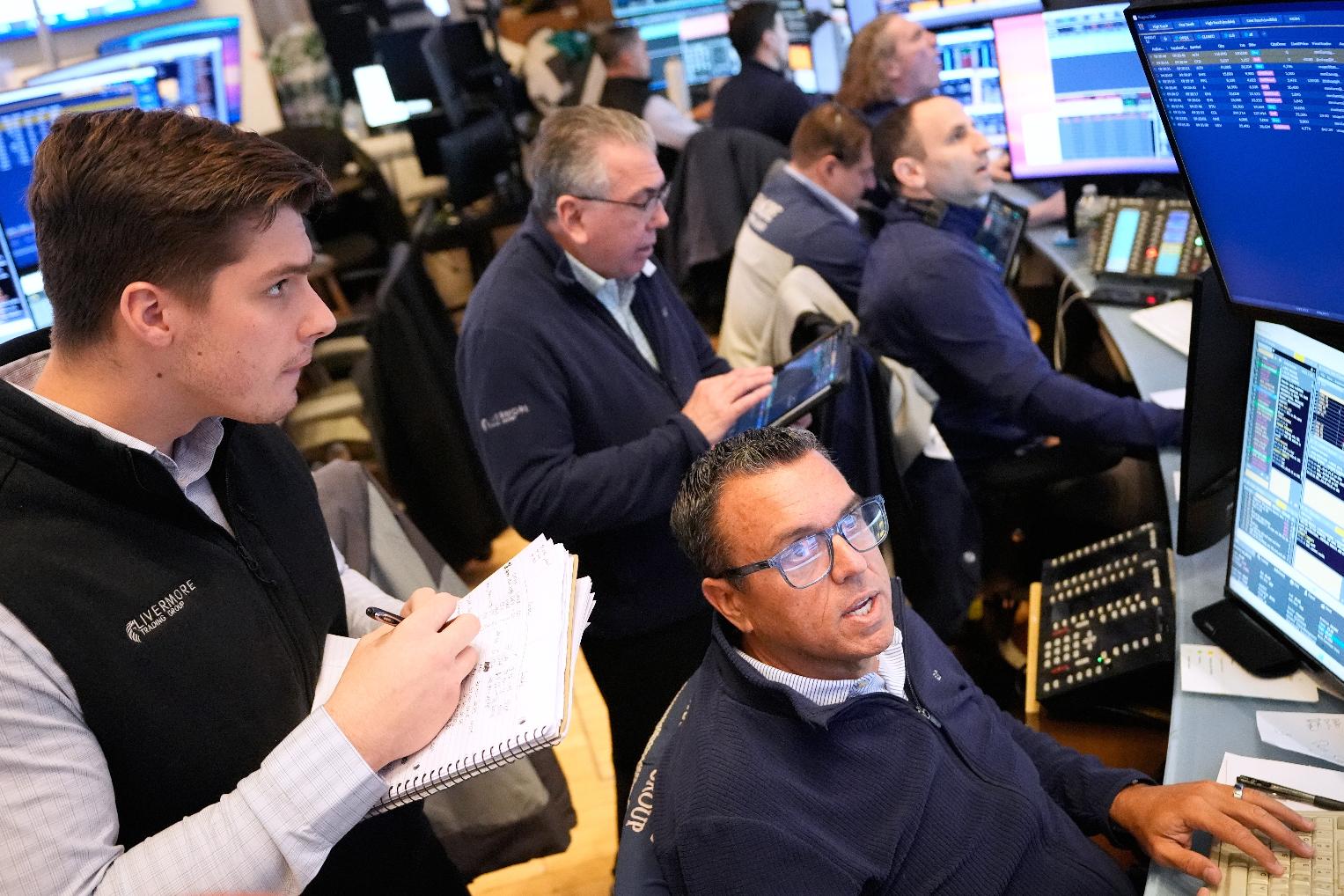 Traders work on the floor at the New York Stock Exchange in New York, Monday, March 2, 2026. (AP Photo/Seth Wenig)