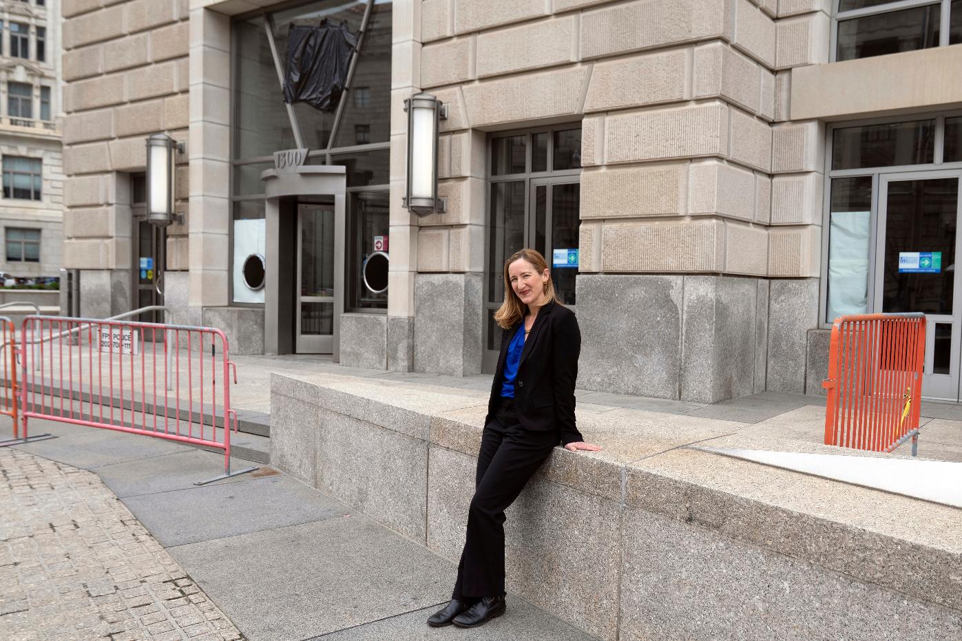 Laura Meissner poses for a portrait in front of the United States Agency for International Development (USAID) headquarters, Wednesday, April 2, 2025, in Washington. (AP Photo/Rahmat Gul)