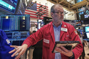 Trader William Lawrence works on the floor of the New York Stock Exchange, Friday, Feb. 13, 2026, in New York. (AP Photo/Richard Drew)