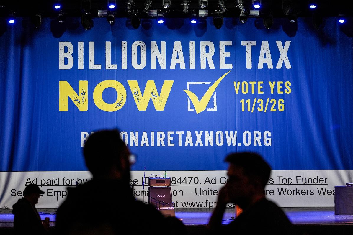 FILE - A large banner is seen at a campaign event for a proposed "billionaires tax" in Los Angeles on Feb. 18, 2026. (AP Photo/Jae C. Hong, File)
