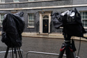 Cameras are covered with rain covers as journalists wait for a showing of Britain's Prime Minister Keir Starmer at 10 Downing Street in London, Monday, May 11, 2026.(AP Photo/Alberto Pezzali)