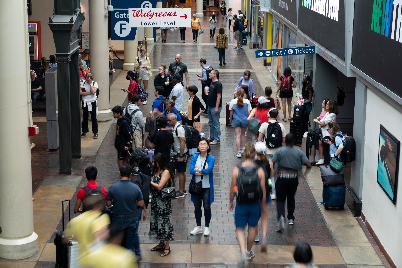 FILE - Travelers walk with their luggage through Union Station in Washington ahead of the Fourth of July holiday, July 1, 2023. Millions of Americans are preparing to get out of town sometime in the coming Fourth of July holiday week, which will likely mean busy roads as well as packed airports and train stations. (AP Photo/Stephanie Scarbrough, File)